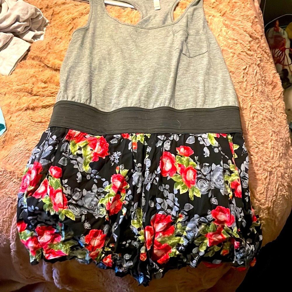 This is a romper with a grey too half and a black with flower bottom half